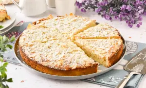 Tarta de almendras dorada y espolvoreada con azúcar glas, lista para servir.