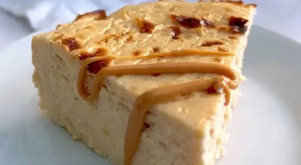 Rebanada de tarta de queso al horno con caramelo líquido.