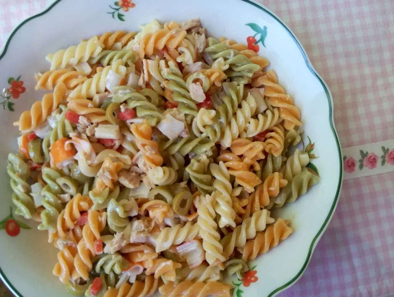 Deliciosa ensalada de pasta tricolor con atún, aceitunas y pimientos. Un plato fresco y perfecto para cualquier ocasión.