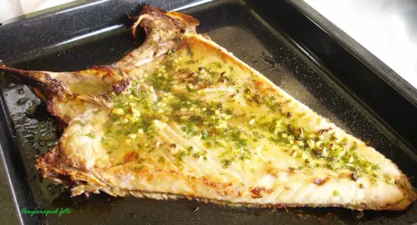Deliciosa ventresca al horno, dorada y jugosa, con un aderezo de ajo y perejil.